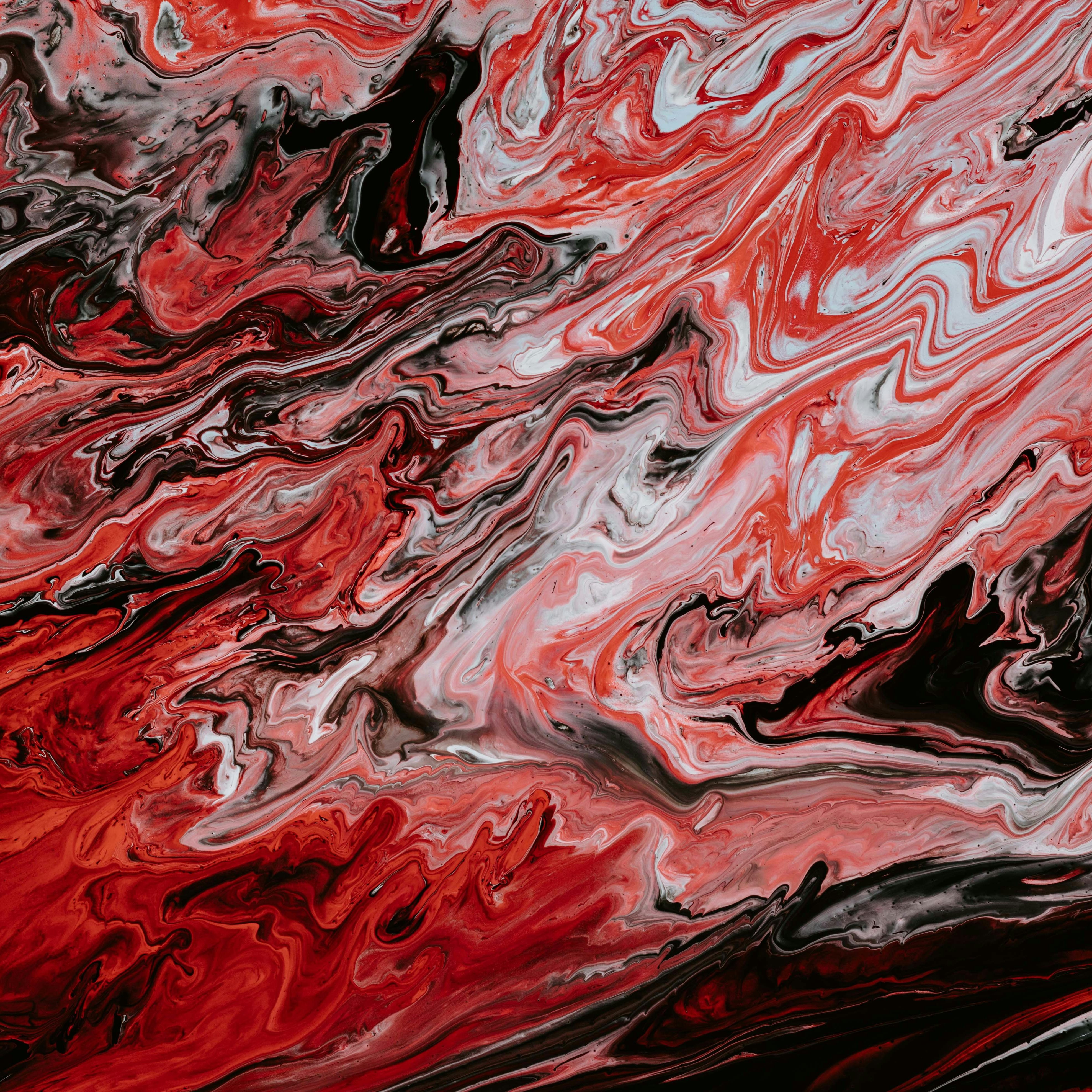 Cette image présente un motif abstrait avec des tourbillons de rouge, noir et blanc. Les couleurs se mélangent de manière fluide, créant une sensation de mouvement et d'énergie. Le rouge prédomine, évoquant des émotions intenses, tandis que le noir apporte une profondeur et un contraste. Les ondulations et les courbes suggèrent un dynamisme, presque comme une danse de couleurs qui se chevauchent et s'entrelacent. L'ensemble évoque une atmosphère à la fois passionnée et mystérieuse.