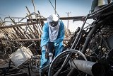 Almoustapha Alhacen uses a scintillometer to measure the radioactivity of scrap metal at Arlit.